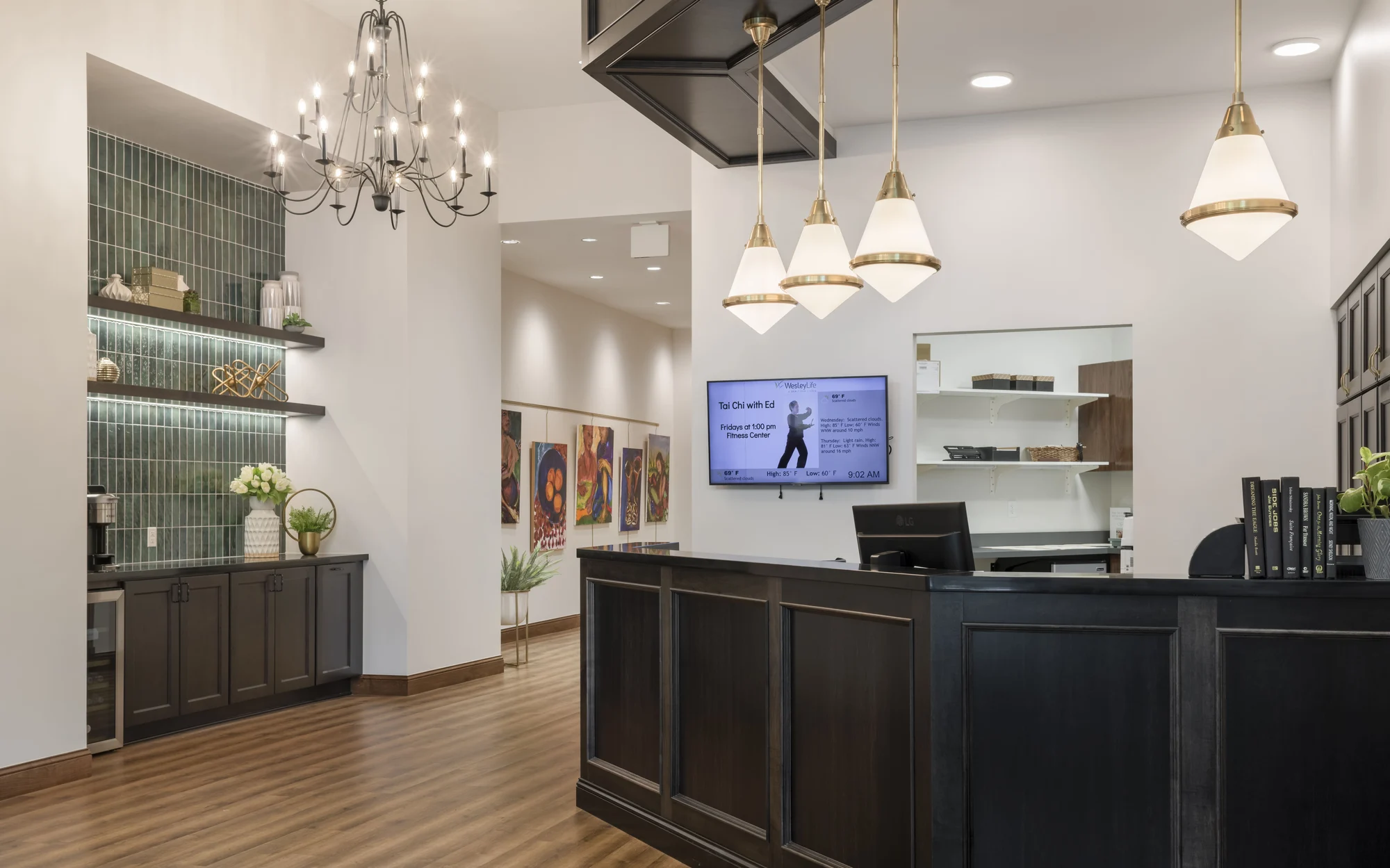 A modern reception area with a chandelier, desk, and decorative elements.