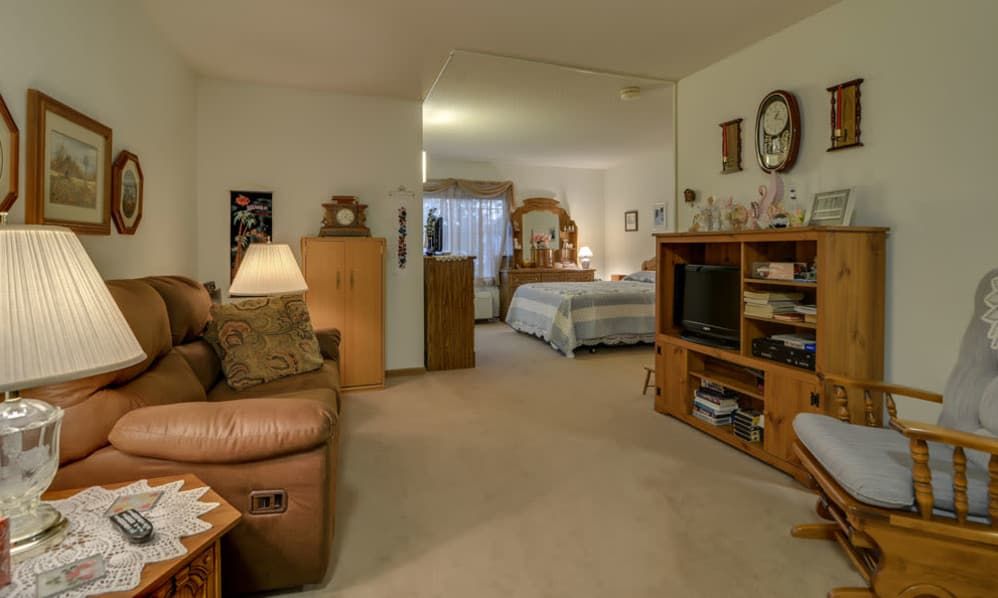 A cozy living space featuring a combined living room and bedroom with comfortable furniture and homey decor.
