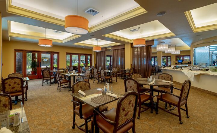 An elegant restaurant dining area with neatly arranged tables and ambient lighting.