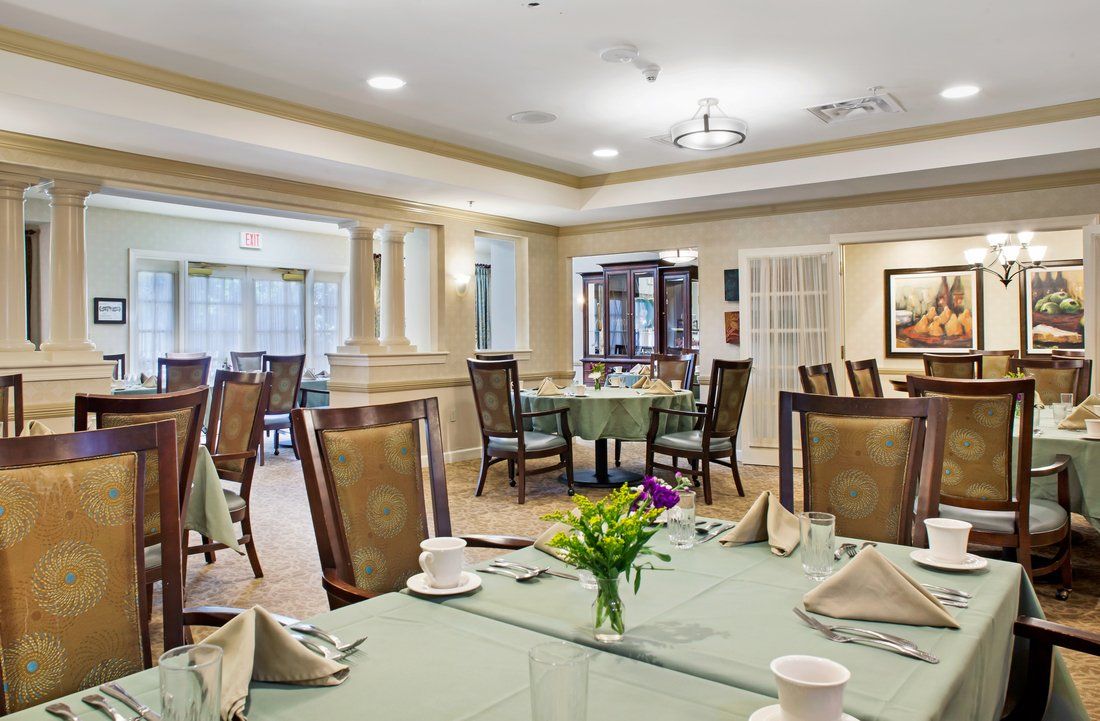 An elegant dining room with neatly set tables and comfortable seating.