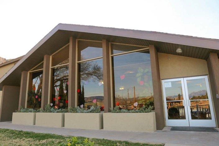 Modern restaurant exterior with large windows.