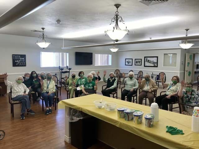 A group of people seated in a community room for a gathering.