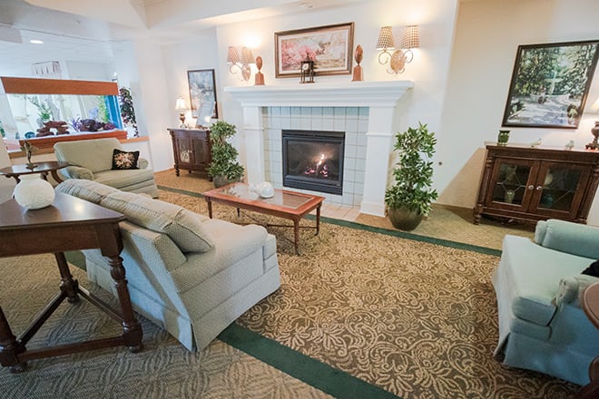 A cozy living room with a fireplace and comfortable seating.