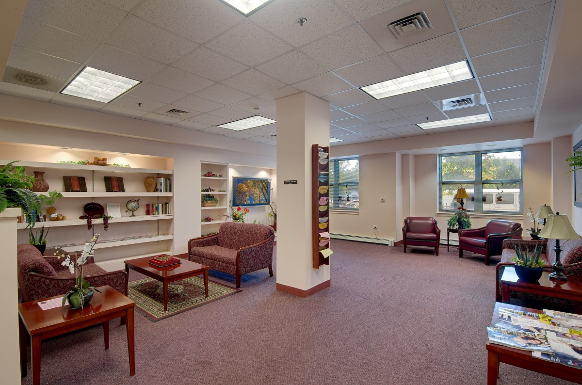 A cozy library with comfortable seating and bookshelves filled with books.