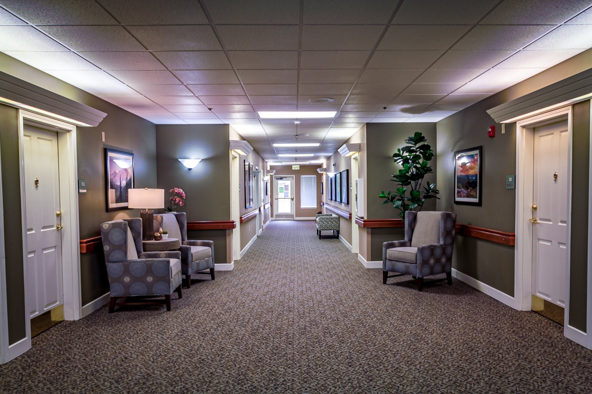 A well-lit hallway with chairs and decorative elements.