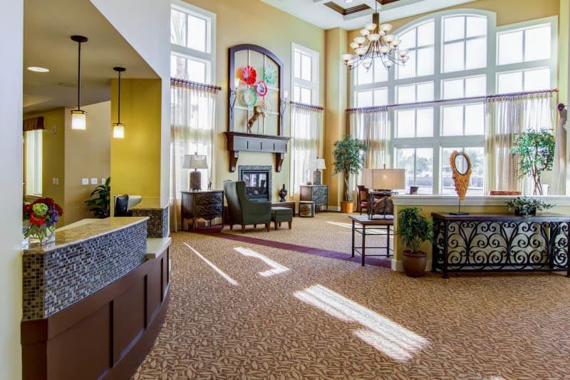Spacious lobby with large windows, comfortable seating, and elegant lighting.