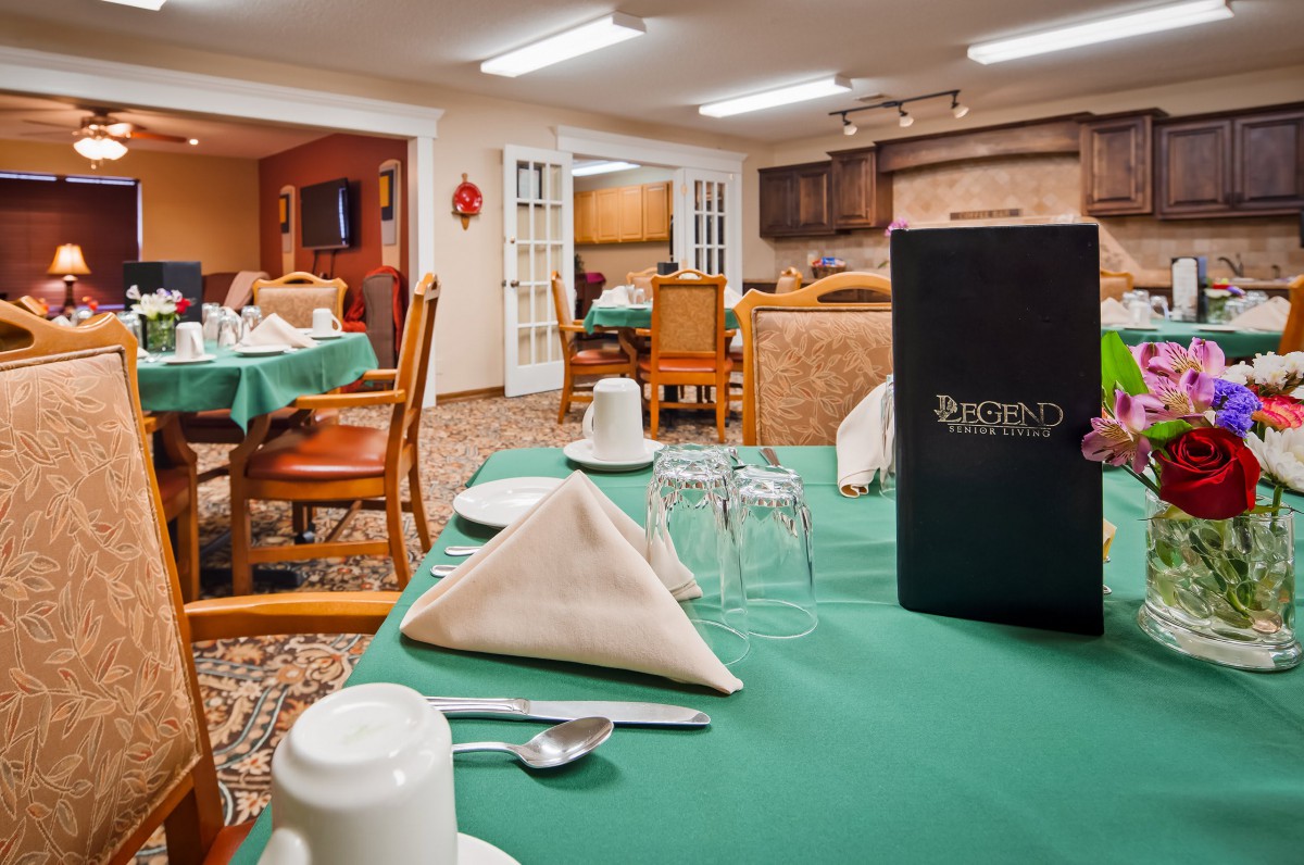 A well-set dining area in a restaurant with neatly arranged tables and chairs.