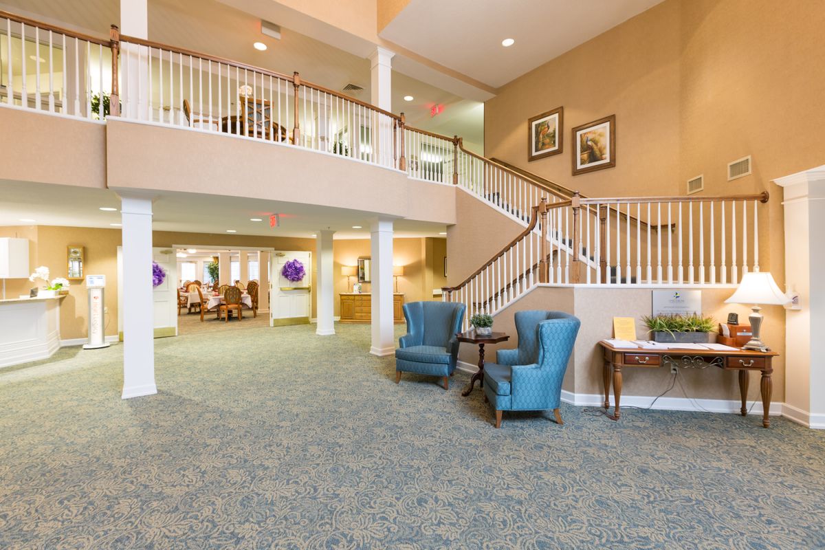 A bright and welcoming lobby with comfortable seating and a staircase.