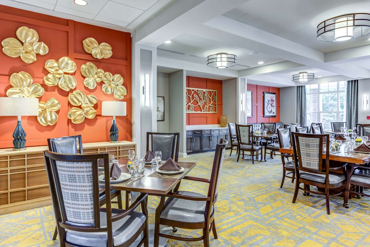 A stylish dining room with elegant furnishings and decorative wall art.