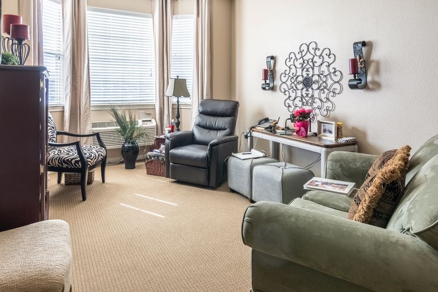 A cozy living room with a recliner, sofa, and decorative elements.