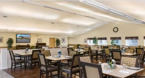 An indoor dining room with neatly arranged tables and chairs.