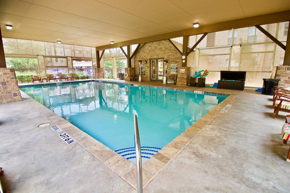 An inviting indoor swimming pool area with clear water and spacious surroundings.