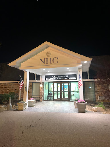 The entrance of NHC illuminated at night.