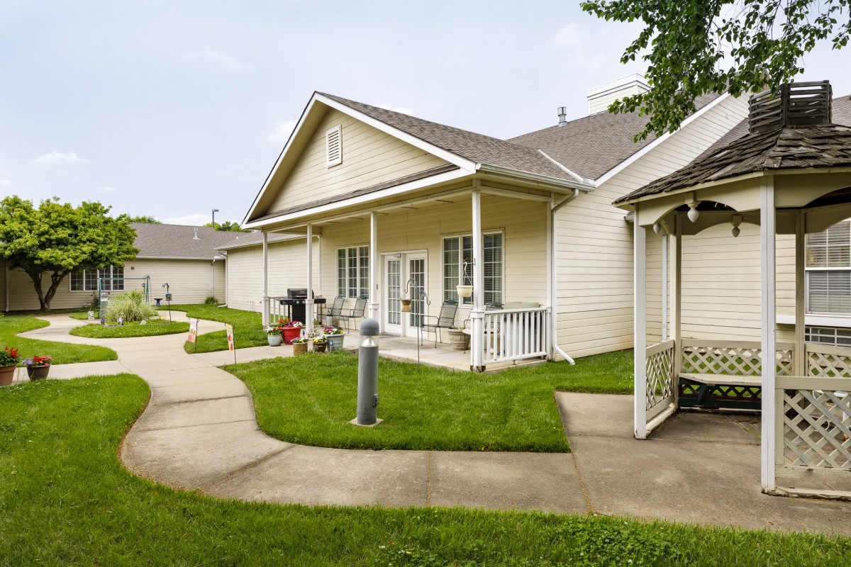 A suburban house with a well-maintained lawn and porch.