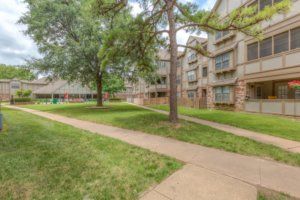 A quiet residential area with apartment buildings and green spaces.
