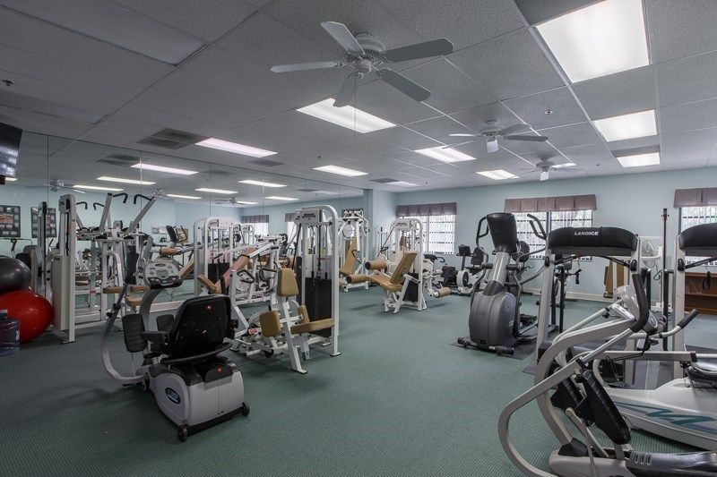 A well-equipped gym featuring various exercise machines and weights.