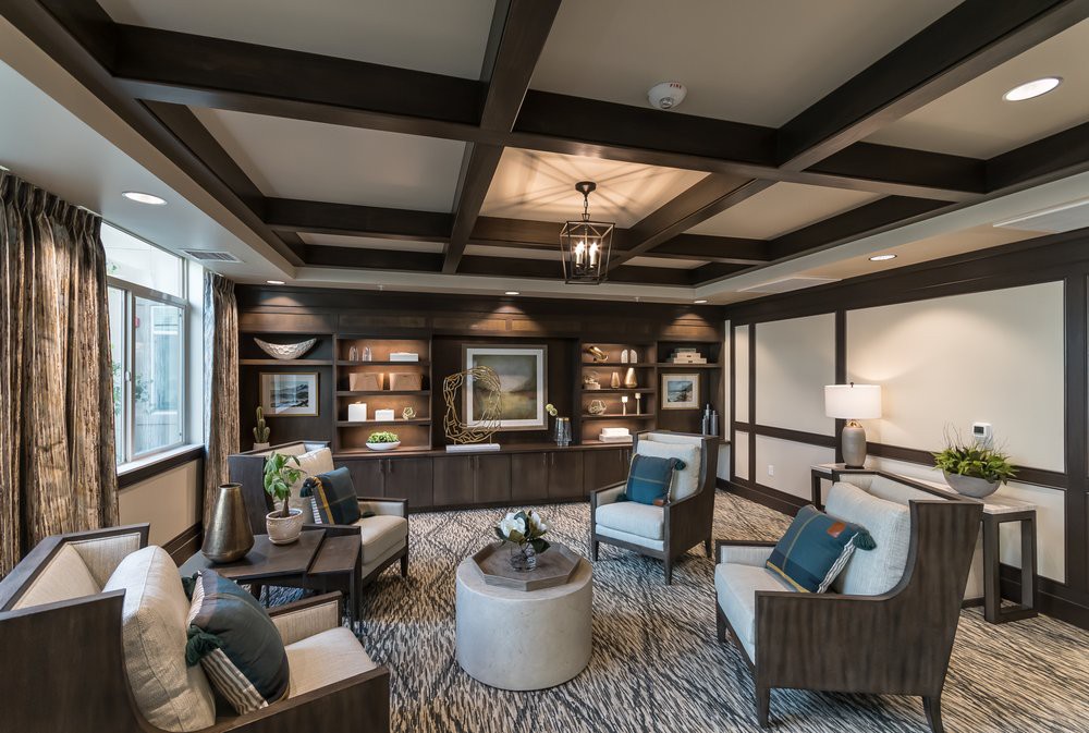 A luxurious living room with elegant furniture and built-in bookshelves.