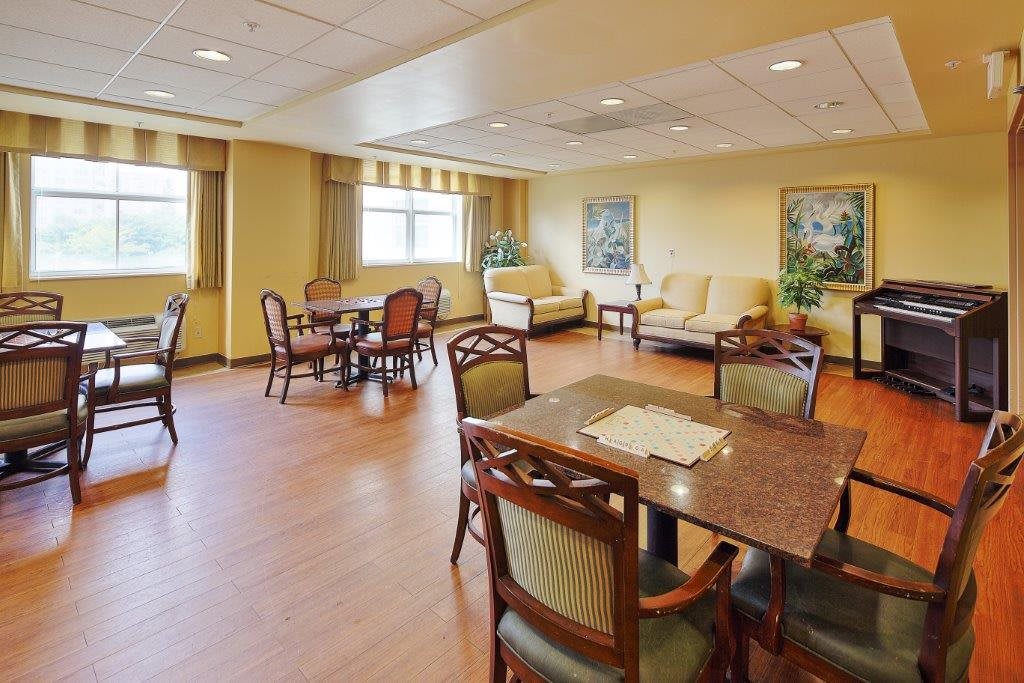 A spacious dining area with wooden furniture and natural lighting.