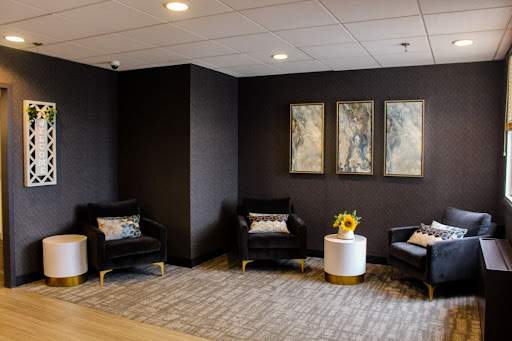 A stylish and modern waiting area featuring comfortable seating, contemporary artwork, and a welcoming atmosphere.