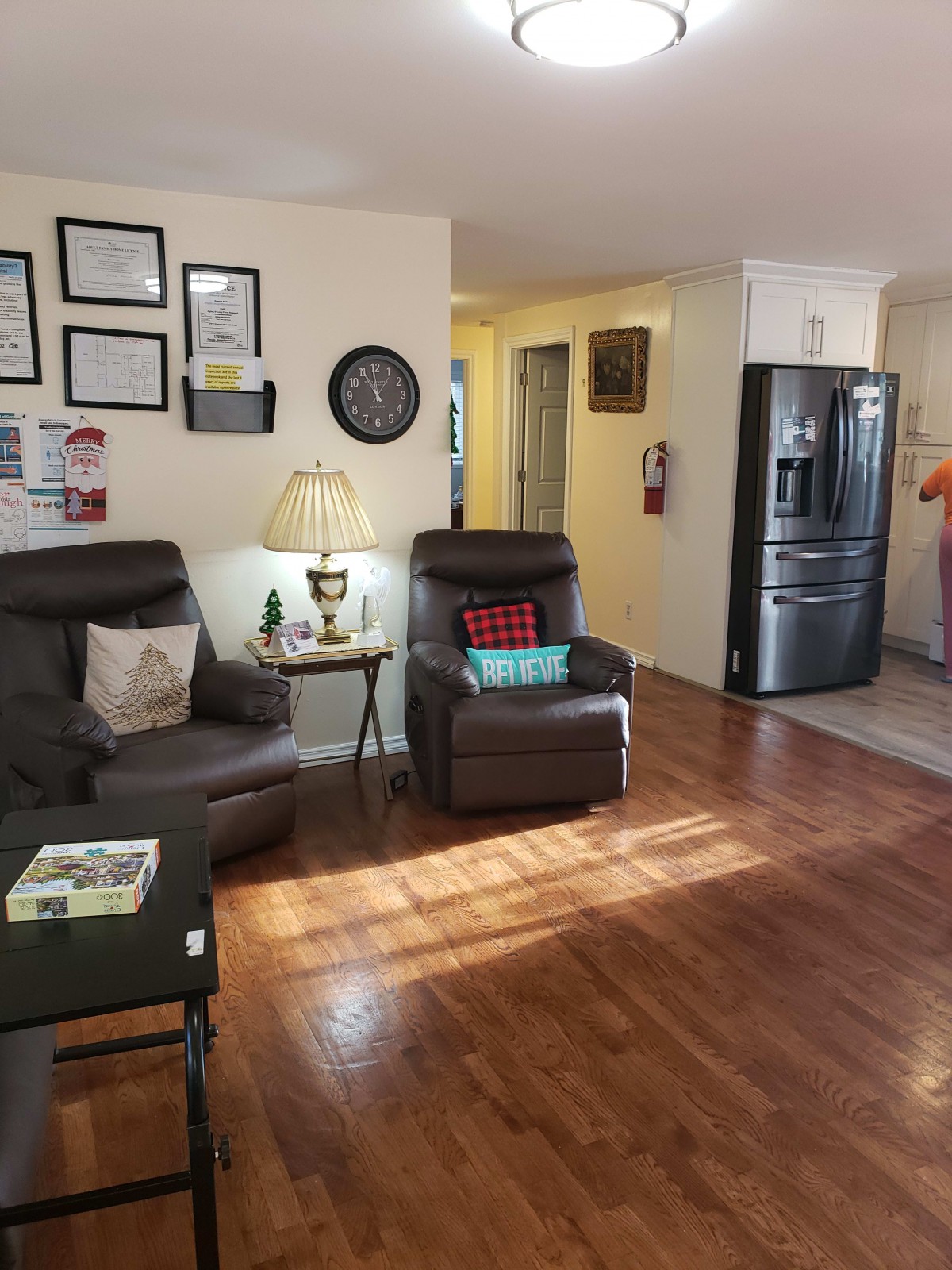 Cozy living room with warm lighting and a glimpse into the kitchen area.
