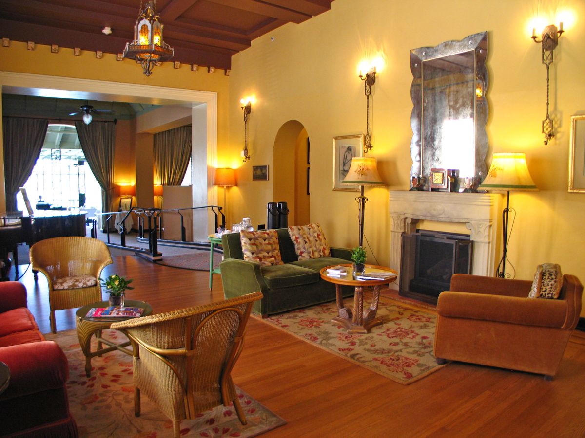 A cozy living room featuring warm lighting, elegant furniture, and a decorative fireplace.