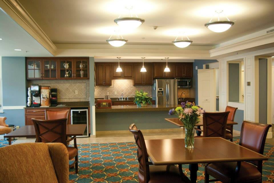 A modern kitchen and dining area with warm lighting and contemporary furnishings.