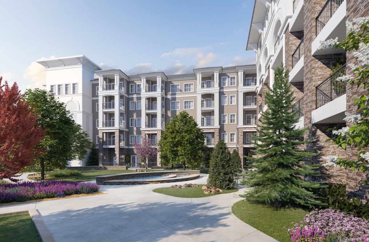 A modern residential complex surrounded by landscaped gardens and greenery.