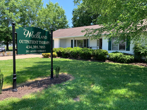 A view of a therapeutic facility surrounded by well-kept lawns and trees.