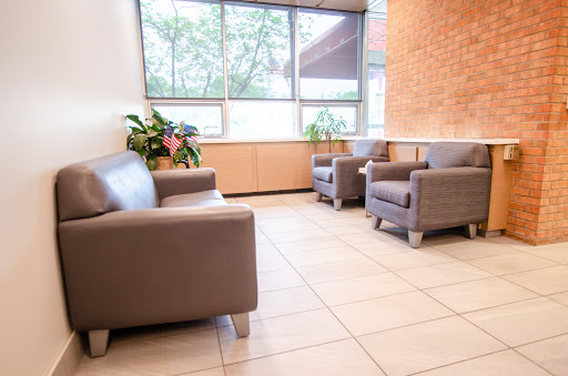 A modern waiting area featuring comfortable seating and natural light.