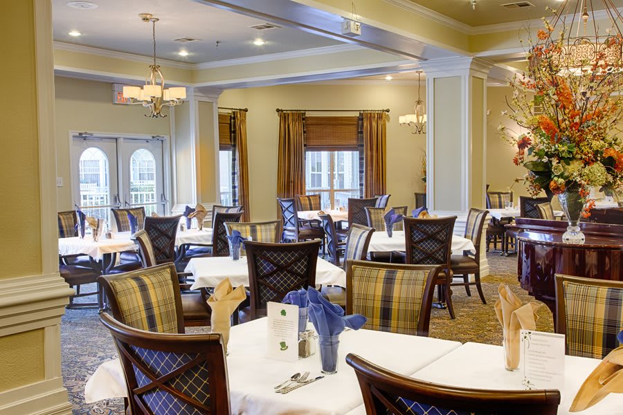 An elegant dining room with neatly arranged tables and chairs.