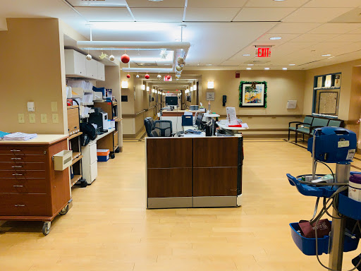 A view of the nurse station in a hospital, showcasing a clean and organized medical environment.