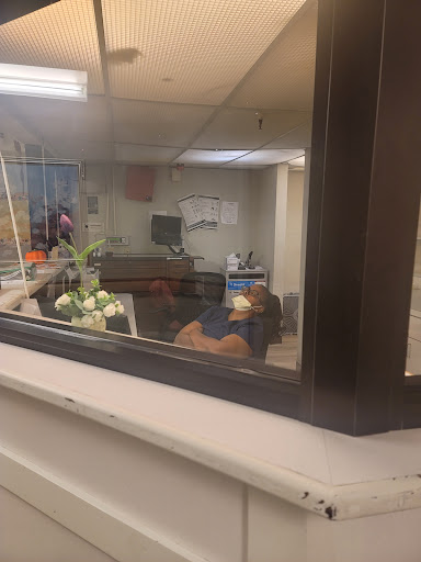 A view through a window into a hospital waiting area.