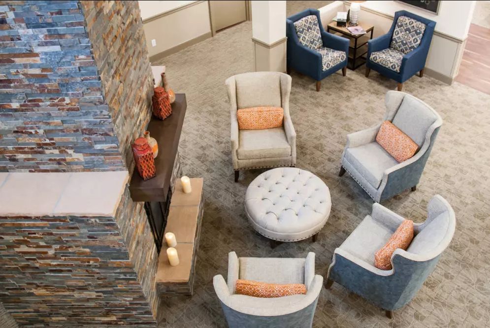 A stylish and comfortable living room with modern chairs and a central coffee table.