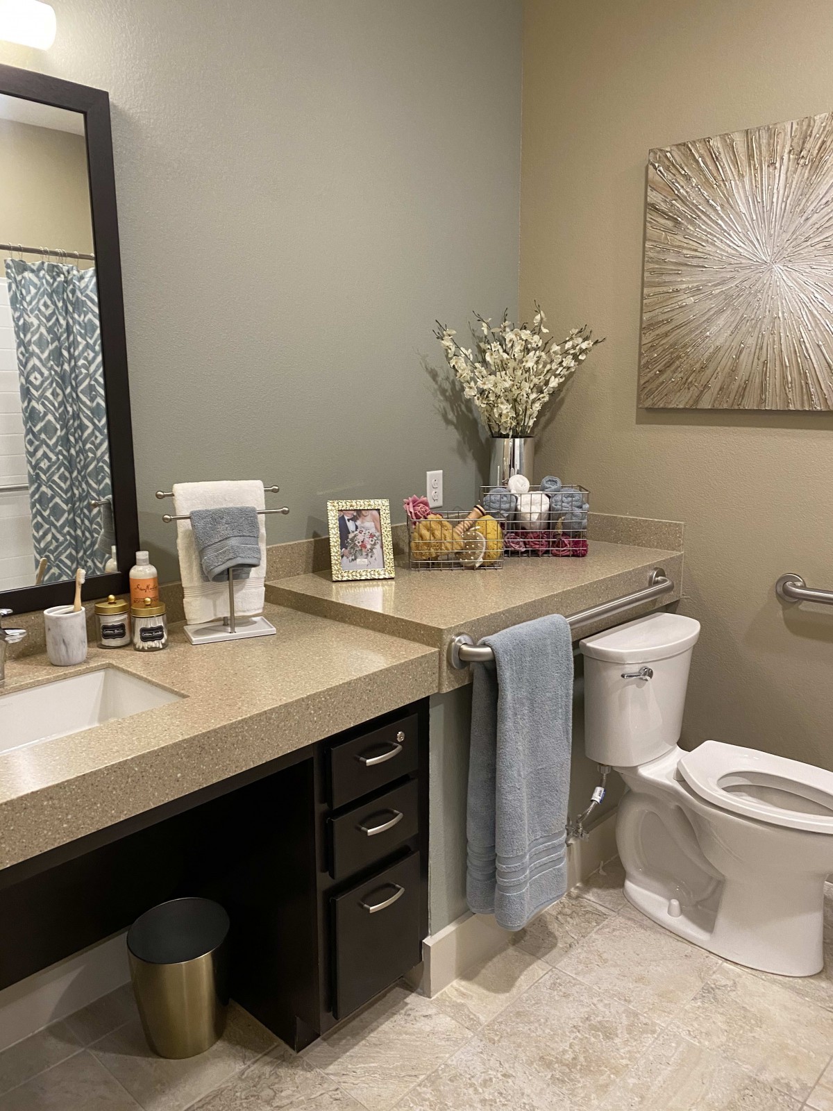A neatly organized bathroom with decorative accents and a modern design.