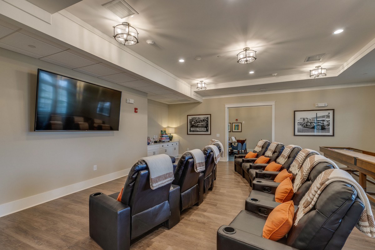 A cozy home theater with comfortable recliner seating and a large screen for entertainment.