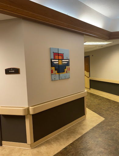 A vibrant abstract painting displayed on the wall of a hospital hallway, adding a touch of color to the environment.