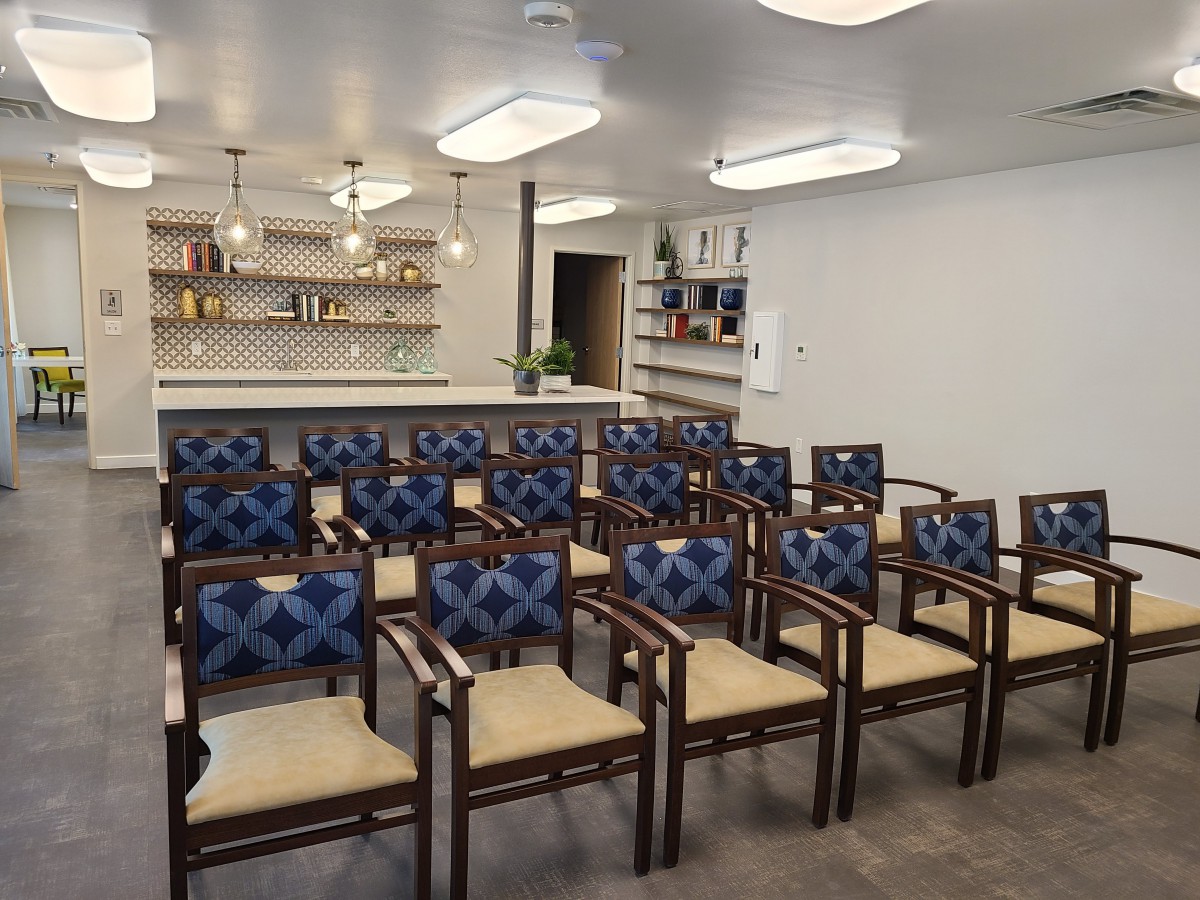 A well-arranged seating area with patterned chairs facing a countertop bar.