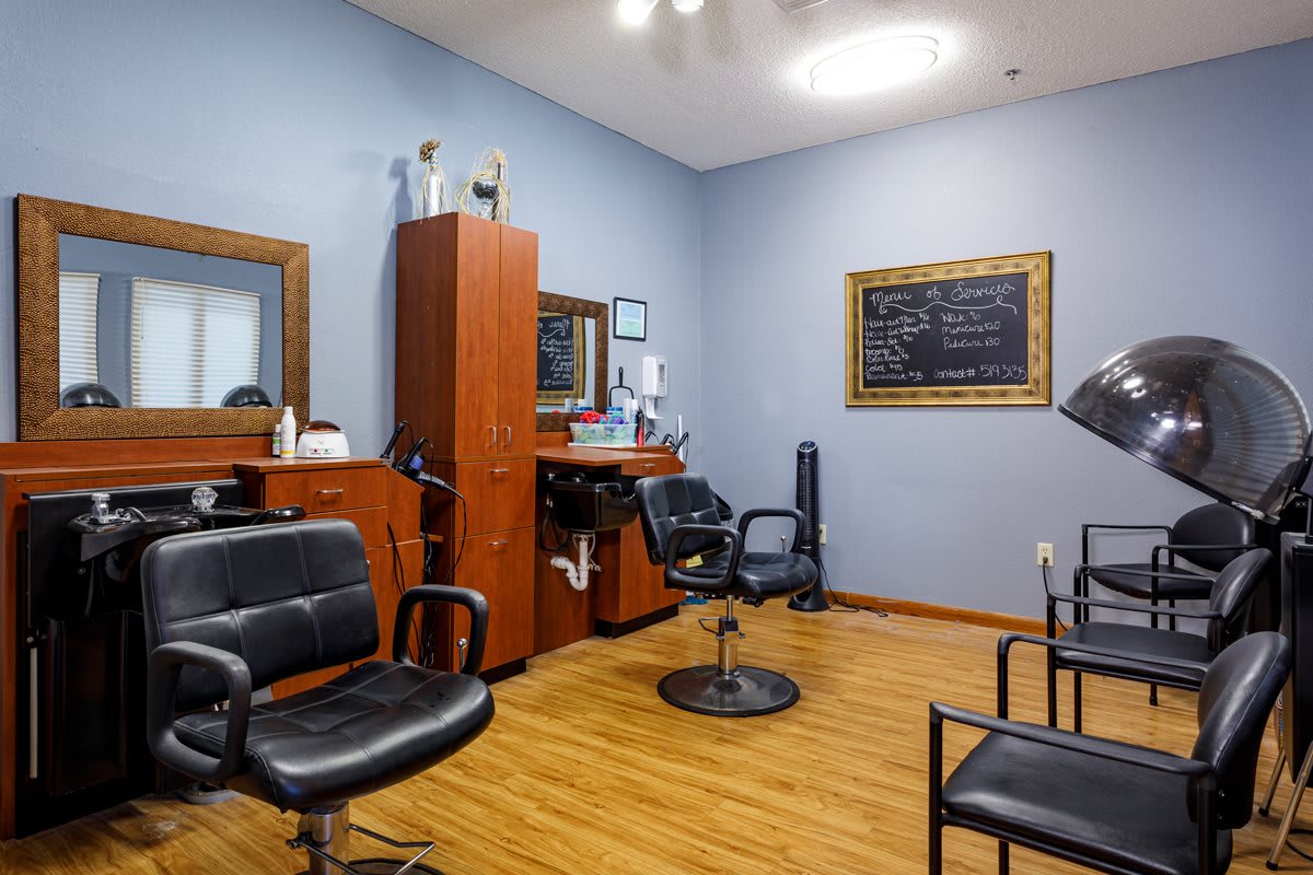 A cozy salon interior with styling stations and chairs.