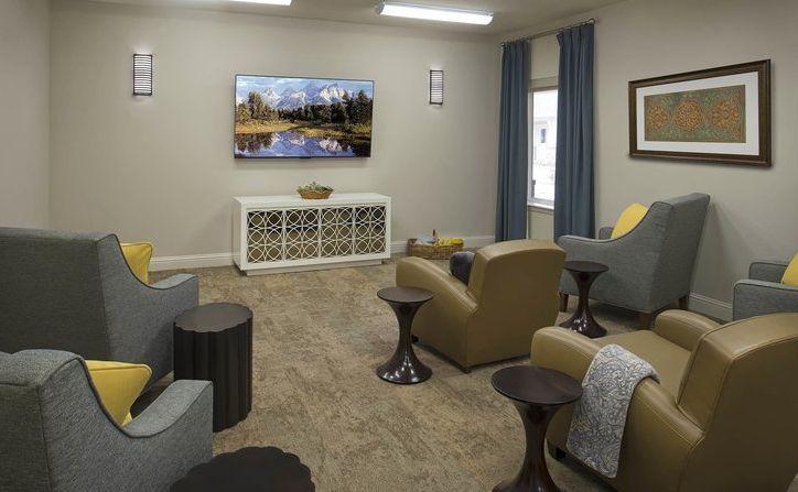A cozy living room with a television, comfortable seating, and tasteful decor.