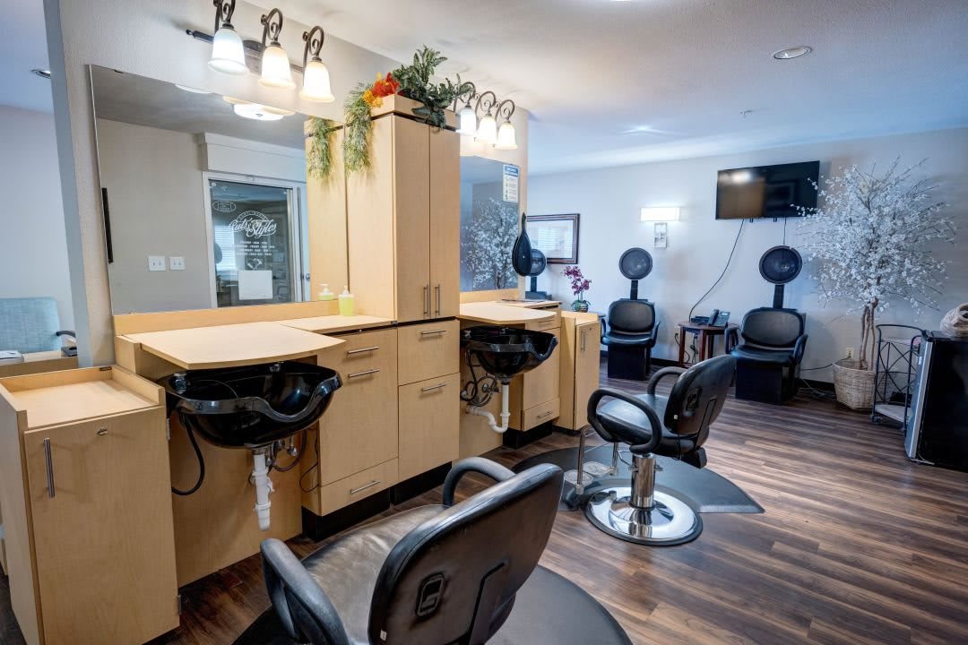 A well-lit hair salon interior with styling chairs and mirrors.