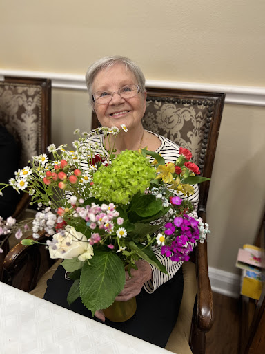 A joyful woman holding a beautiful bouquet of flowers, radiating happiness.