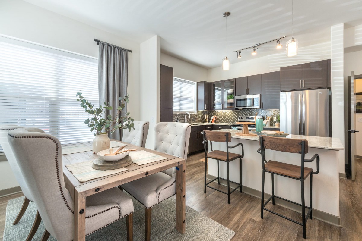 A modern open-plan kitchen and dining area with stylish furnishings.