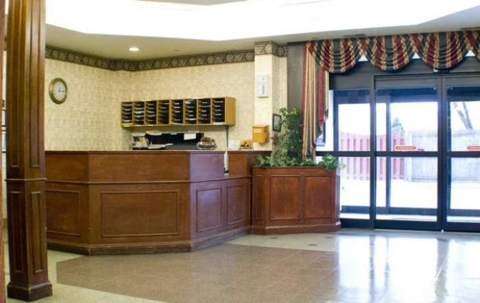A hotel lobby with a reception desk and entrance area.