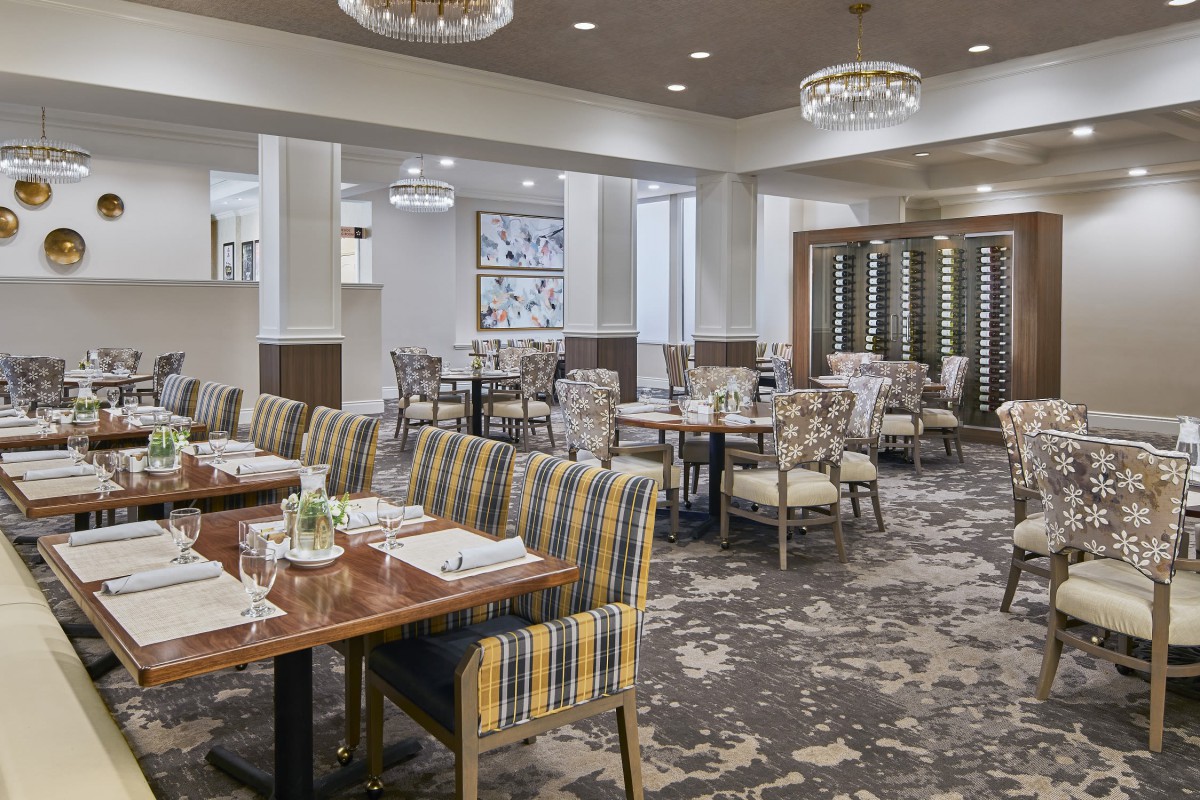 A well-appointed restaurant dining area with stylish furniture and elegant chandeliers.