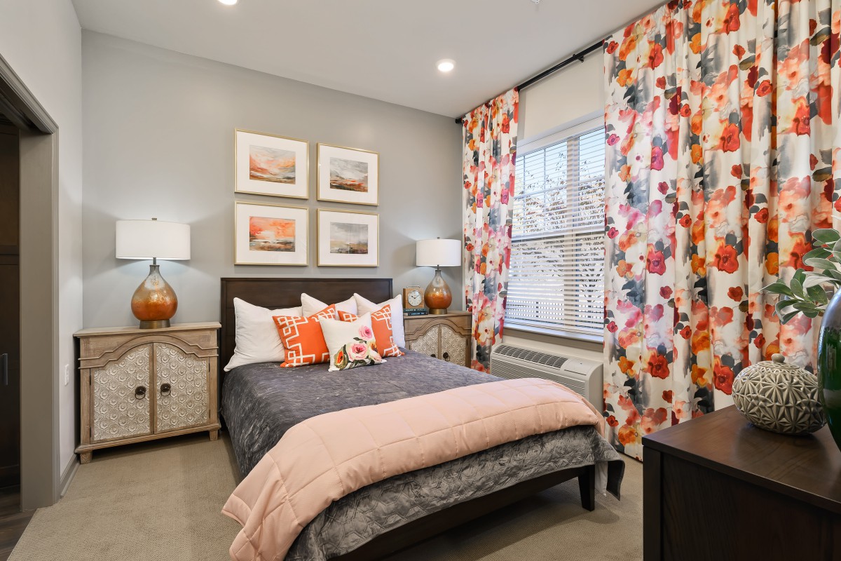 A cozy bedroom with vibrant curtains and modern decor.