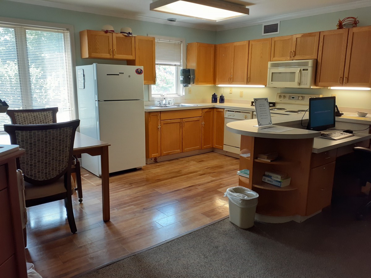 A cozy kitchen with wooden cabinets and modern appliances.