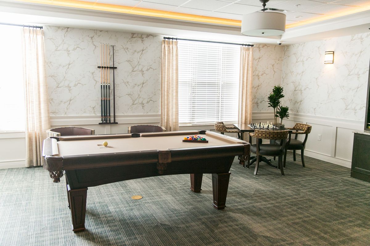 A cozy game room featuring a pool table and seating area.