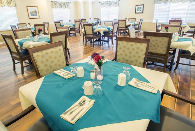 A neatly arranged dining area with tables set for guests.