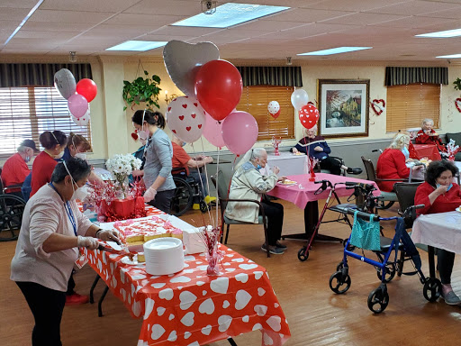 A festive gathering celebrating Valentine's Day at a community center for seniors.