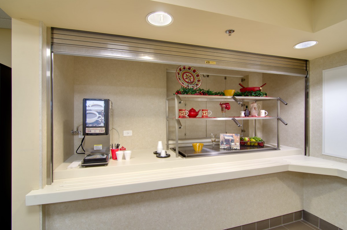 A self-service cafeteria food station with drink and food options available.